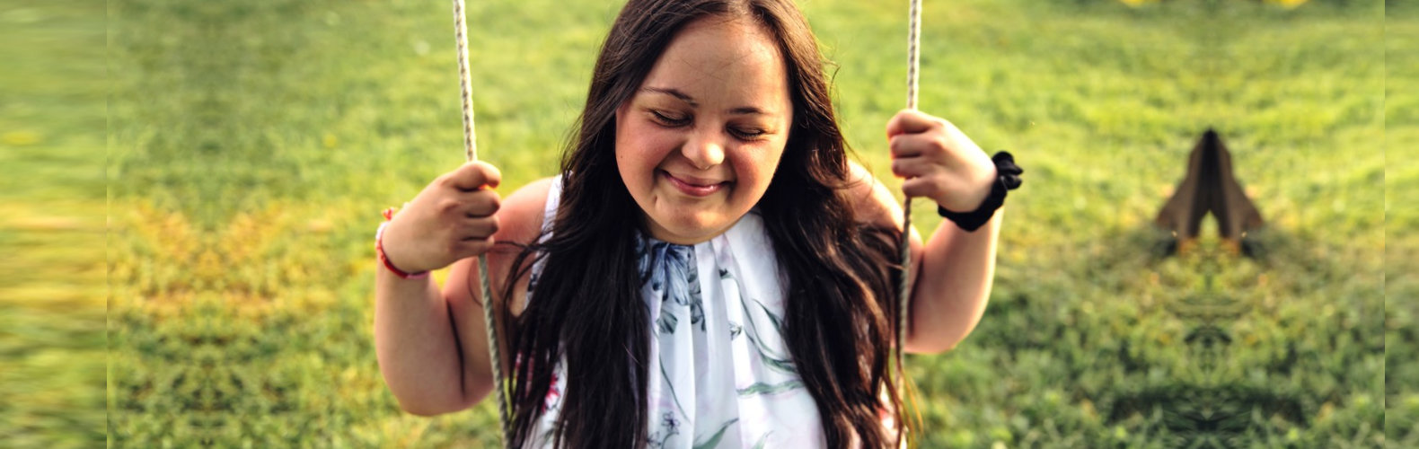 special child sitting on the swing smiling